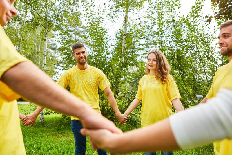 Young people hold hands stock image