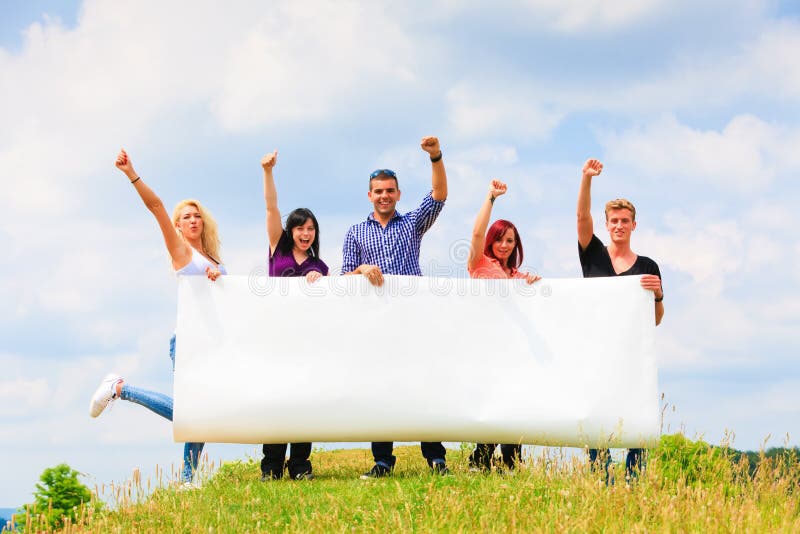 Young People Holding A Big Poster royalty free stock photos Young People Holding A Big Poster royalty free stock photos