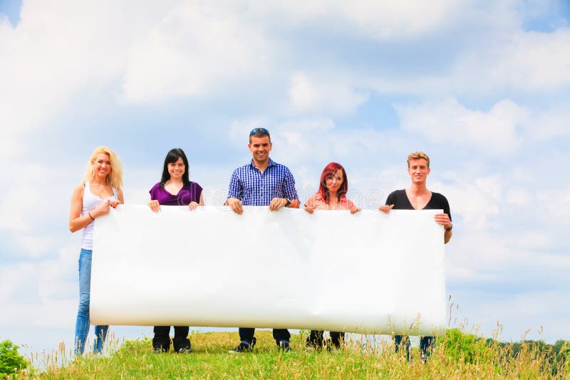 Young People Holding A Big Poster stock images Young People Holding A Big Poster stock images