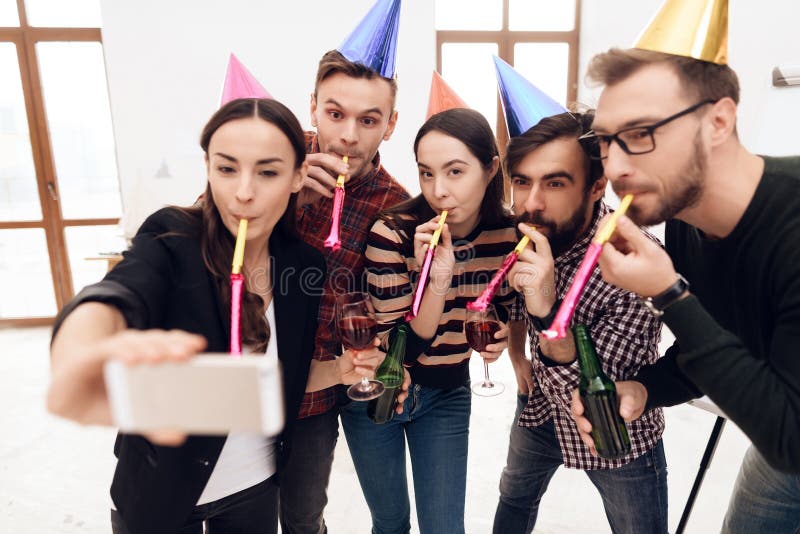 Young people in holiday caps do selfie. royalty free stock images Young people in holiday caps do selfie. royalty free stock images
