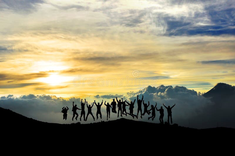 Young people having fun in the mountain submit at the sunset time. It is a picture from the Pacaya volcano in Guatemala. Young people having fun in the mountain submit at the sunset time. It is a picture from the Pacaya volcano in Guatemala