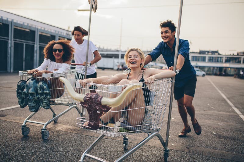 Young people racing with shopping trolleys royalty free stock images Young people racing with shopping trolleys royalty free stock images