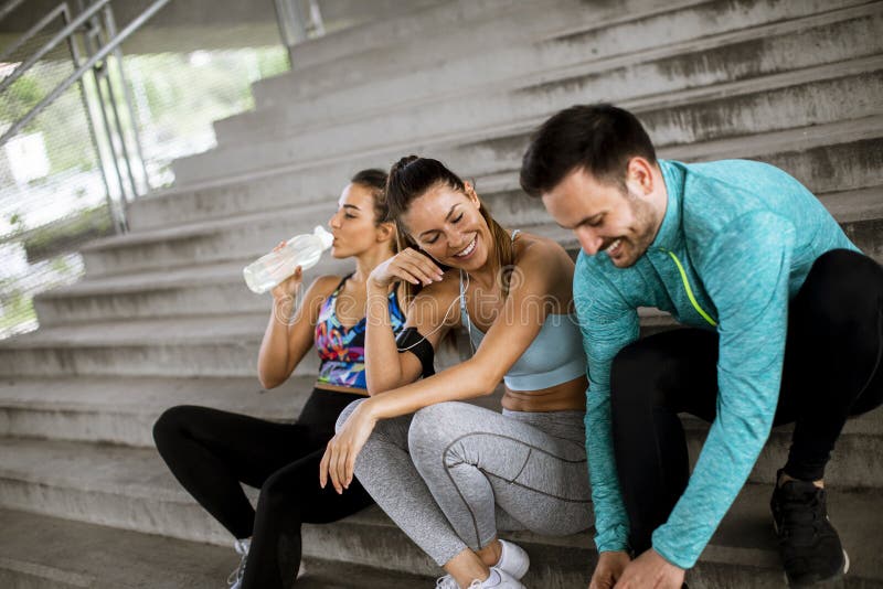 Young people resting during training with bottle of water royalty free stock image