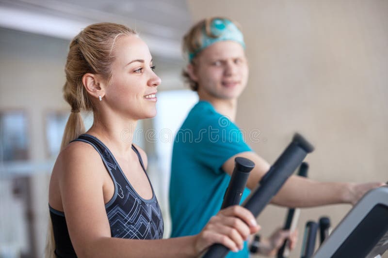 Young people on run simulators in gym royalty free stock photos Young people on run simulators in gym royalty free stock photos