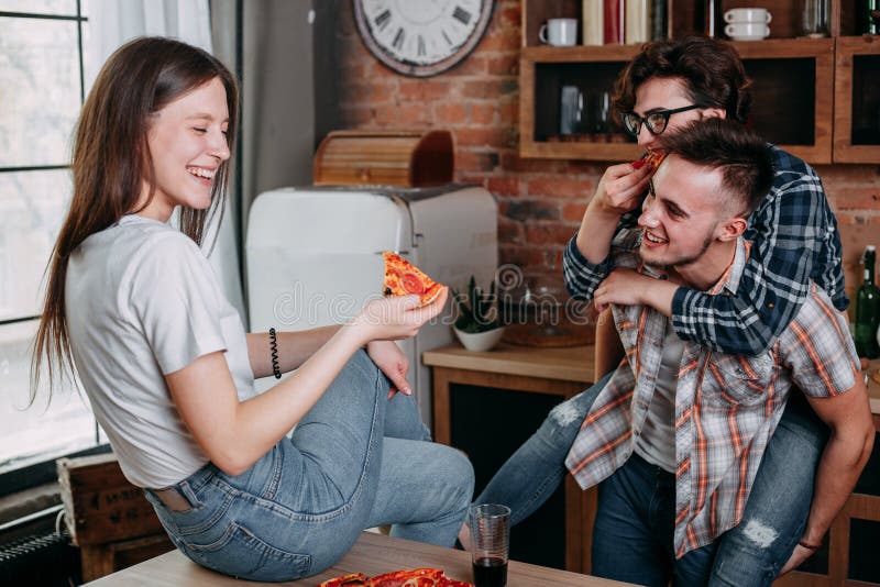 Group Of Friends Eating Pizza Together At Home Stock Photo, Picture and  Royalty Free Image. Image 56950664.