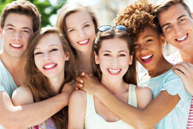 Young friends embracing and smiling. Young friends embracing and smiling