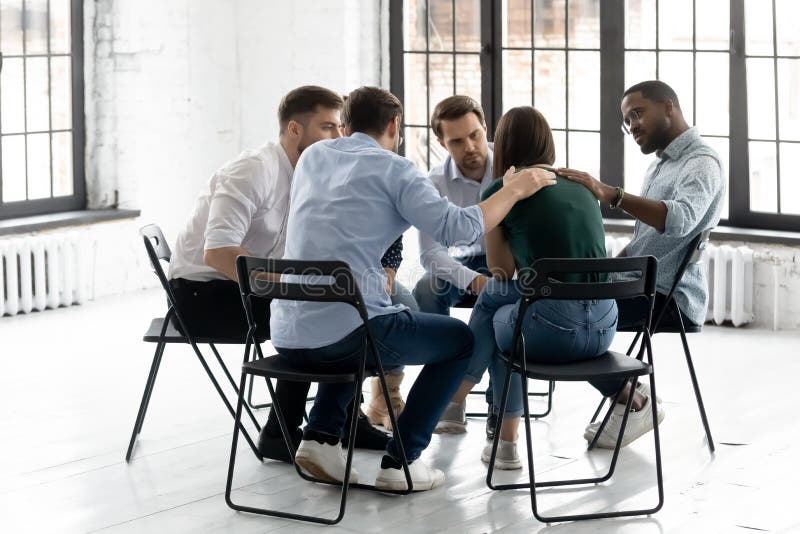 Young people support upset female at group session stock photography Young people support upset female at group session stock photography