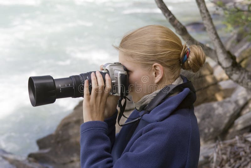 Young photographer with telephoto lens