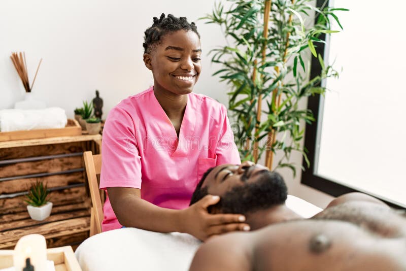 Young Physiotherapist Woman Giving Head Massage To African American Man ...