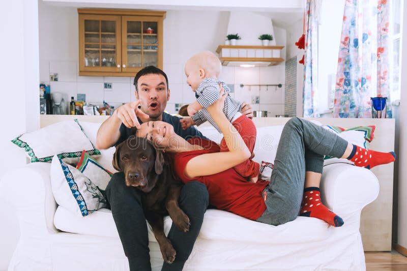 A young playful family at home on the couch. royalty free stock photography A young playful family at home on the couch. royalty free stock photography