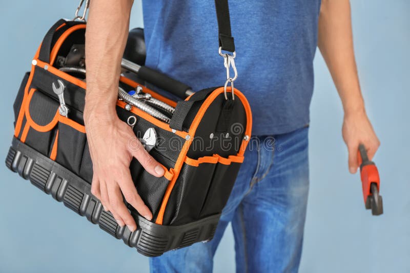 Plumber With Tool Bag On White Background, Closeup Stock Photo