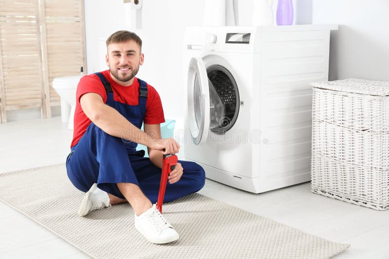 Young Plumber with Wrench Near Washing Machine Stock Image Image of adult, occupation 130797741