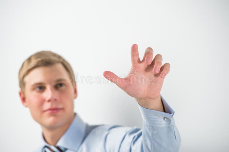 Young positive business man touching virtual button. Editable image stock photo Young positive business man touching virtual button. Editable image stock photo