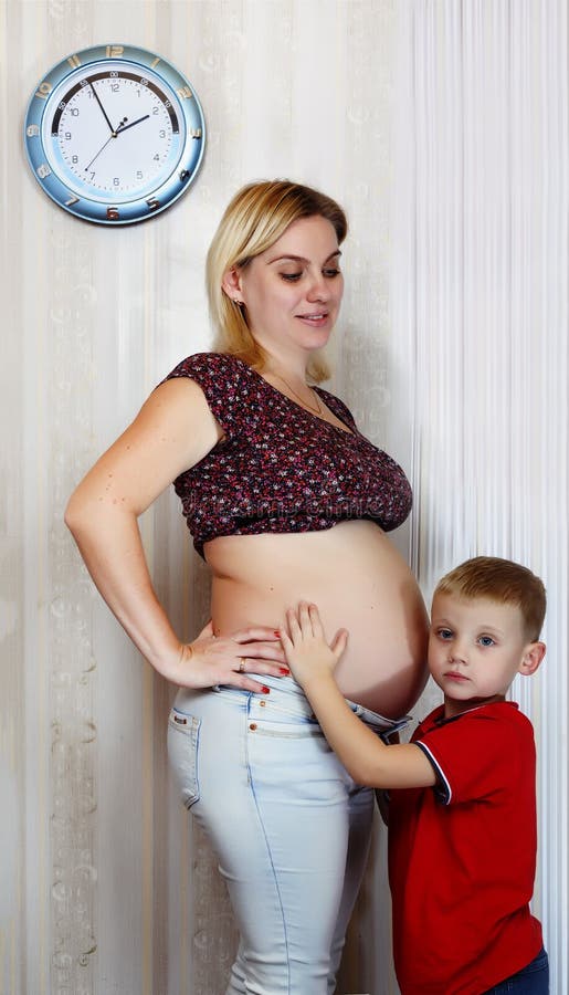 Young pregnant mother with her little son. A happy family. royalty free stock photos Young pregnant mother with her little son. A happy family. royalty free stock photos