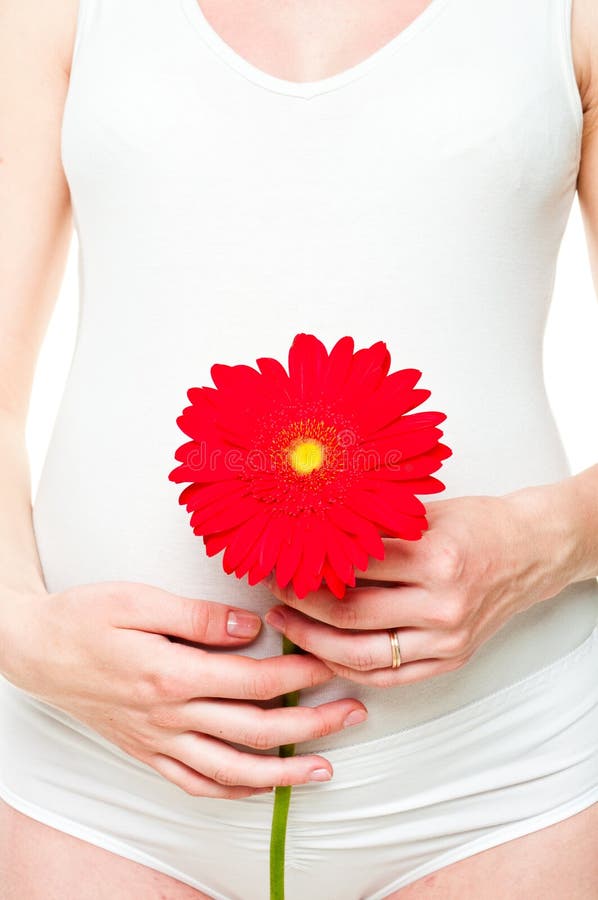 Young pregnant woman with flower