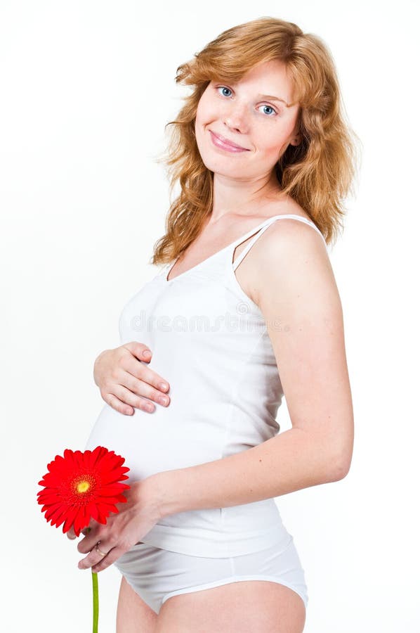 Young pregnant woman with flower