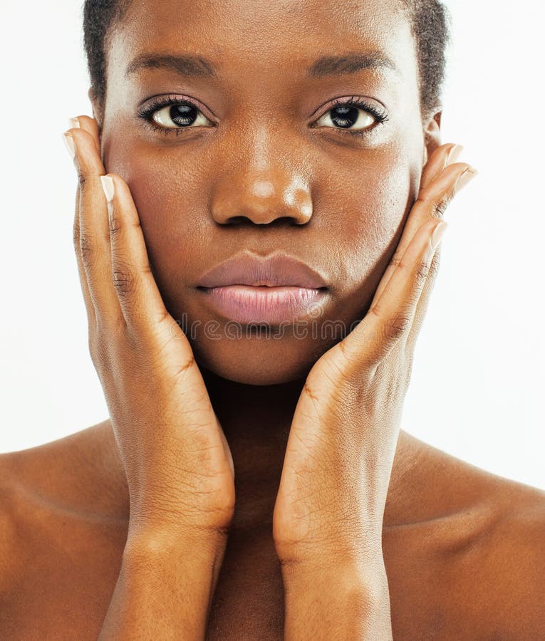 Young pretty african american woman naked taking care of her skin isolated on white background, healthcare people