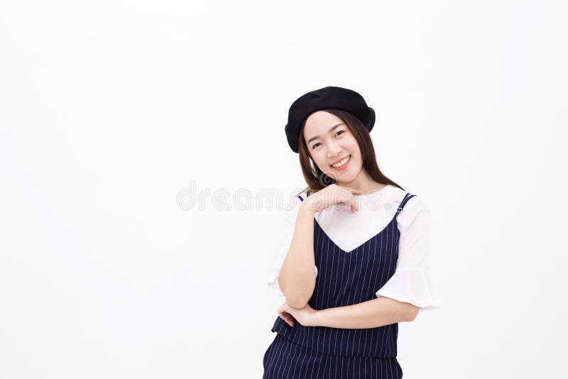 Young and pretty Asian female with artist hat smiling and posing in white isolated background royalty free stock images Young and pretty Asian female with artist hat smiling and posing in white isolated background royalty free stock images
