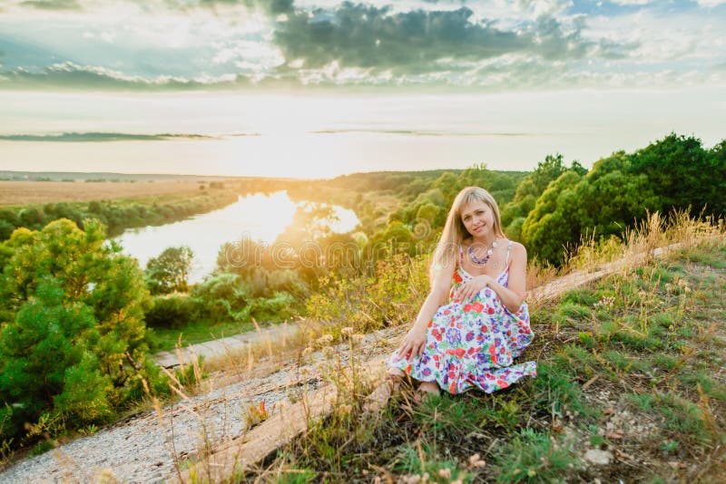 Young pretty blonde and summer sundown stock image
