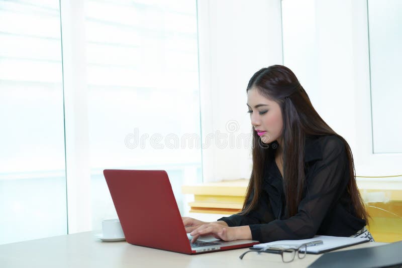Young pretty business woman with notebook in the office stock images