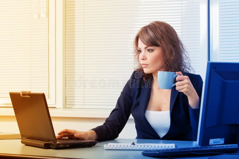 Young pretty business woman in the office