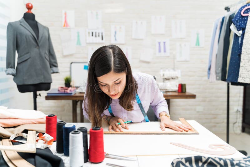 Young Pretty Dressmaker Drawing with Ruler at Atelier Stock Photo ...