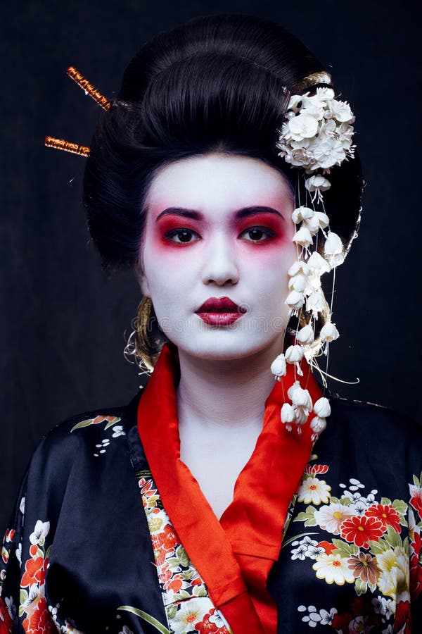 Young pretty geisha in kimono with sakura and decoration