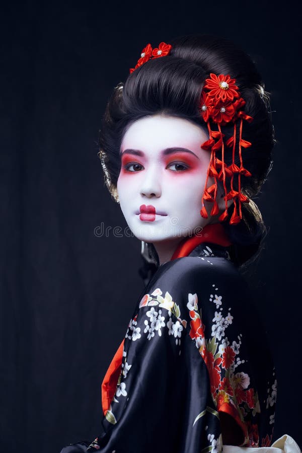 Young pretty geisha in kimono with sakura and