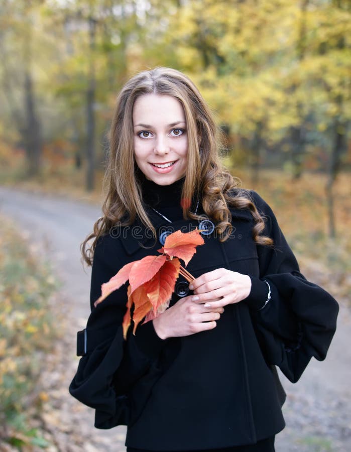 Young pretty girl in fall forest