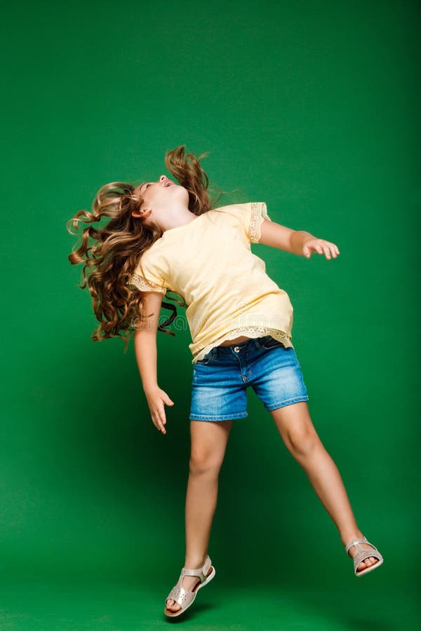 Young Pretty Girl Jumping Over Green Background. Stock Photo Image of health, merry 75155140