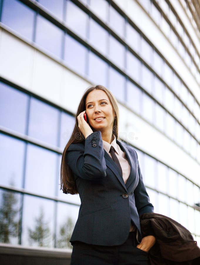 Young pretty girl near business building walking, student in america or europe close up smiling