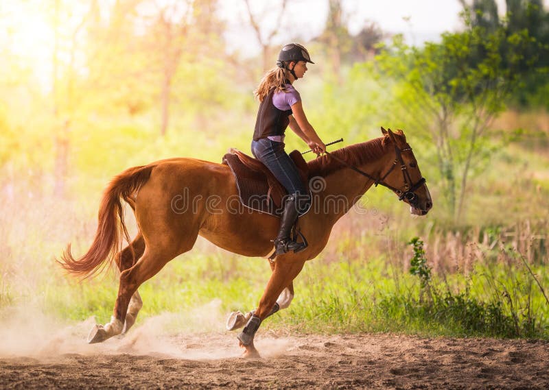 Young pretty girl riding a horse with backlit leaves behind in s