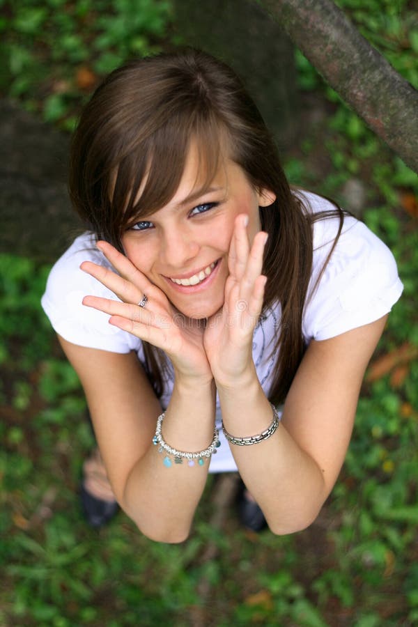 Young pretty girl smiling on the grass.