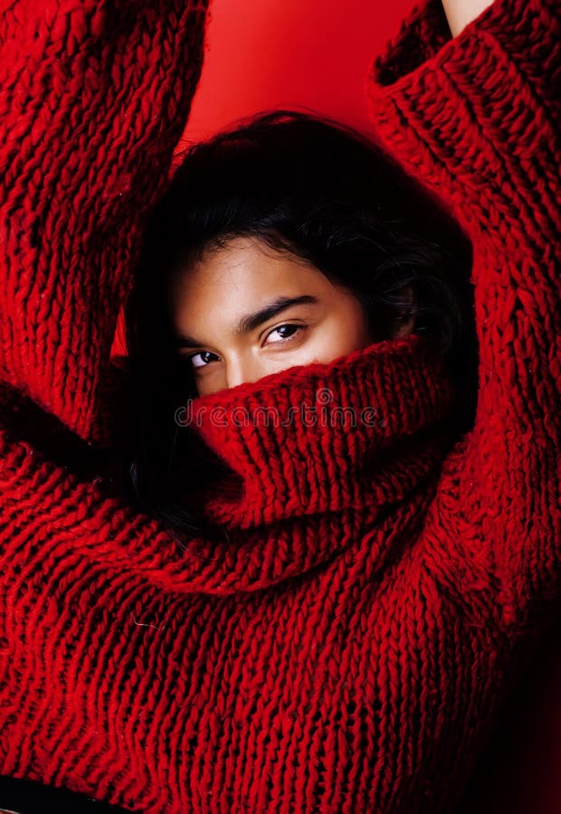 Young pretty indian mulatto girl in red sweater posing emotional, fashion hipster teenage, lifestyle people concept
