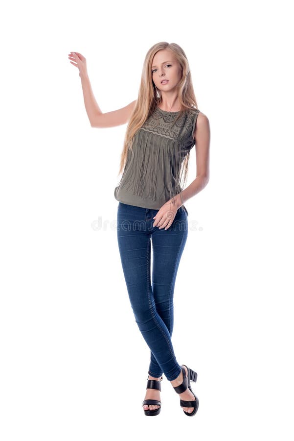 Young Longhair Blonde Woman In Knitted Sweater Posing Against Grungy Gray Wall Scared Or