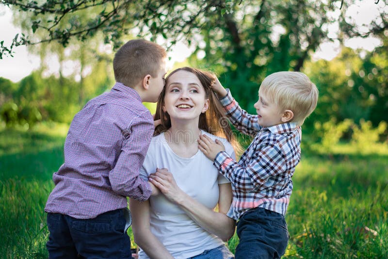 Mom With Two Sons Kiss And Cooking In The Kitchen Stock Image Image