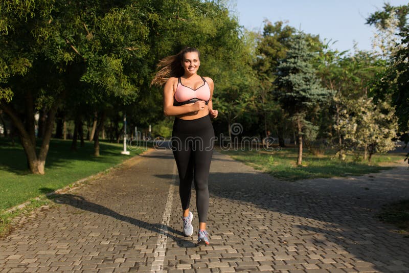 Pretty Plus Size Girl in Sporty Top and Leggings Doing Sport