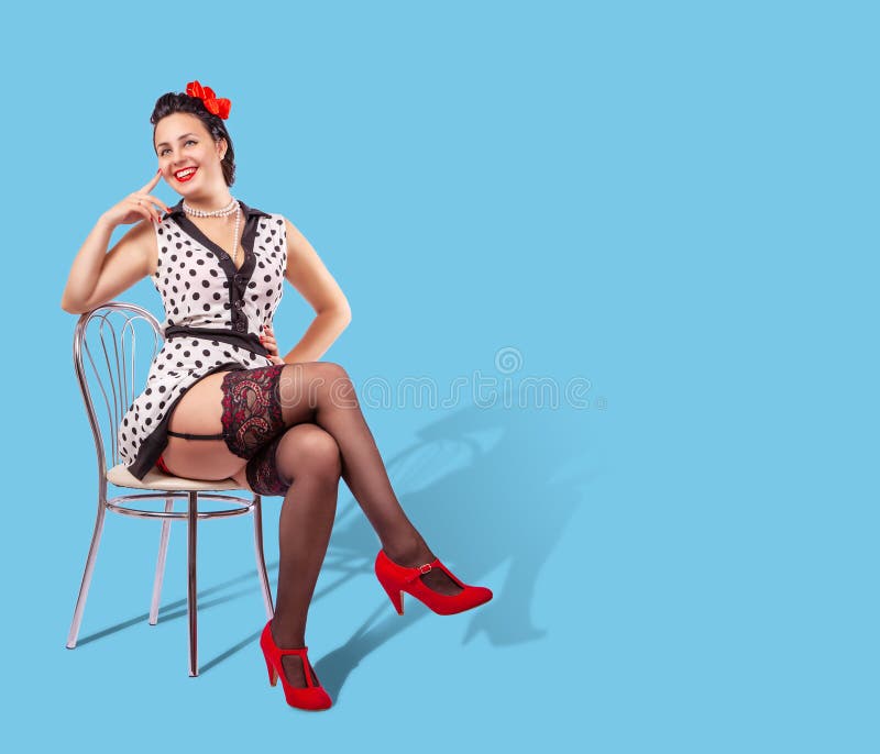 Young pretty smiling woman sitting on a chair. pinup style