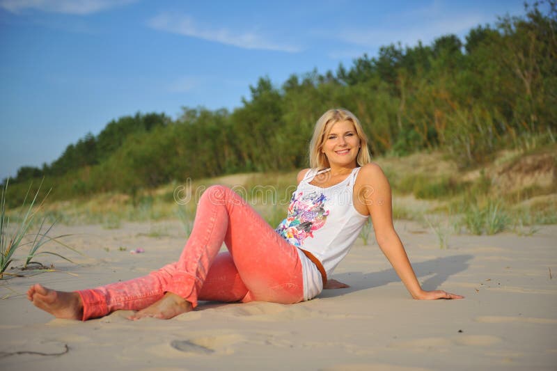 Young pretty summer woman relaxing on the beach