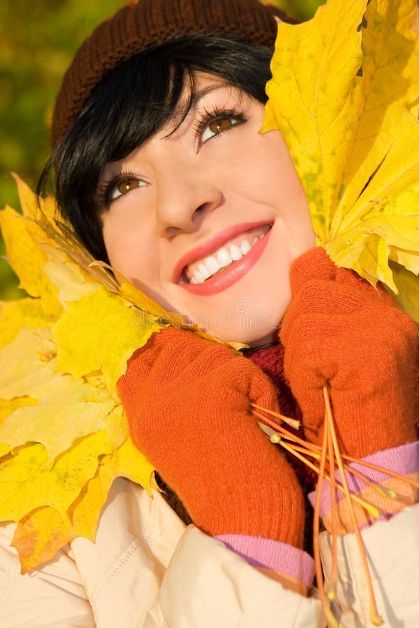 Young pretty woman on the autumn leaf