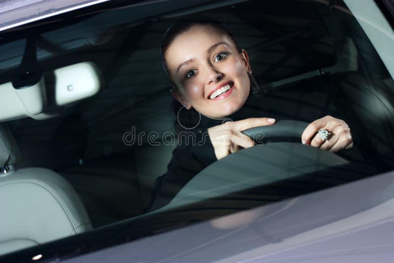 Young pretty woman driving car