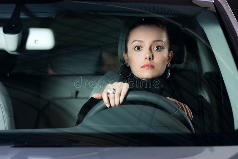 Young pretty woman driving car