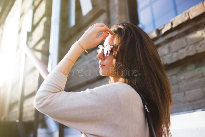 Young pretty woman outdoor fashion portrait. Beautiful girl casual dress and sunglasses