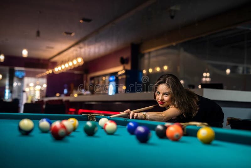 Premium Photo  Beautiful young girl came on a weekend to play billiards  for curiosity concept of a girl playing billiards