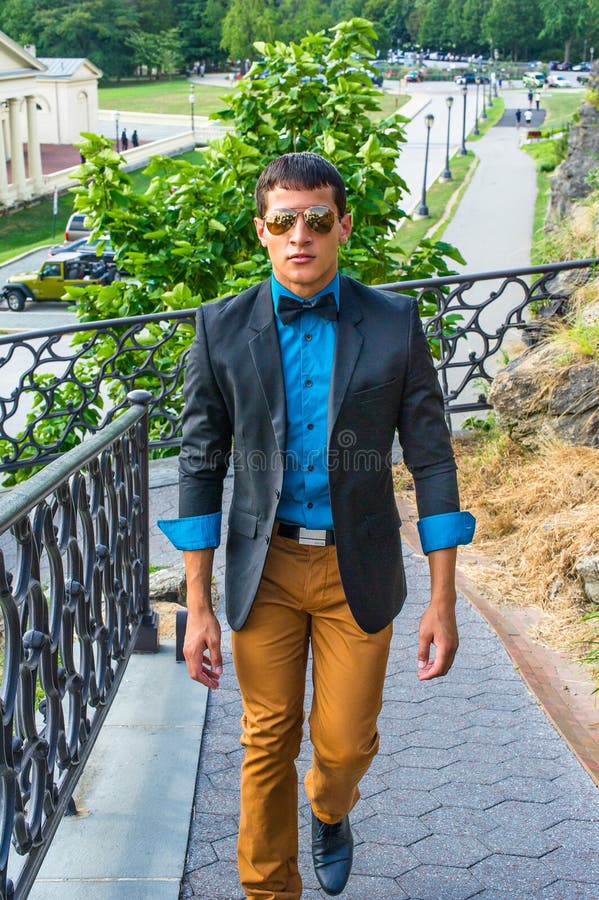 Man leaning on brown concrete post wearing blue dress shirt and brown pants  photo – Free Agra Image on Unsplash