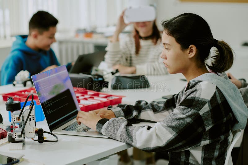 Girl with Pony Tail Coding at Desk royalty free stock photos