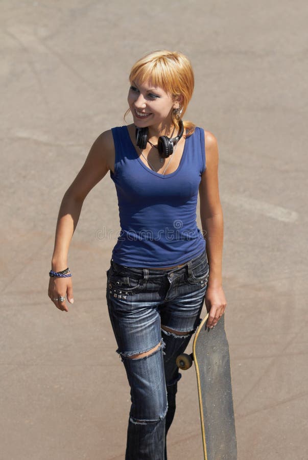 Young punk girl skater with headphones