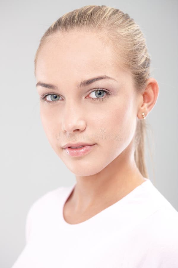 Closeup portrait of young pure face teenager looking at camera confidently.