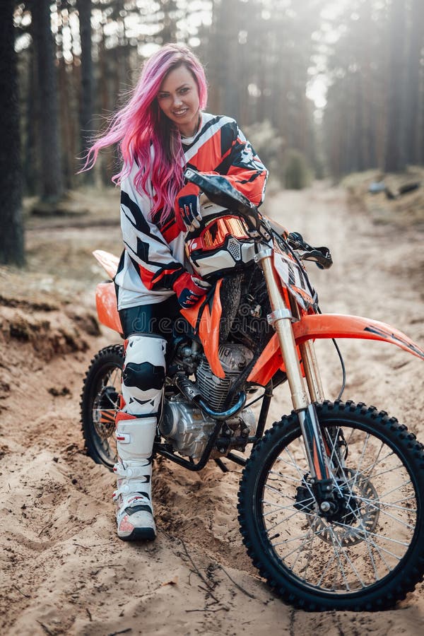 Young Racer Girl with Pink Hair in Motocross Kit Sitting on Her ...