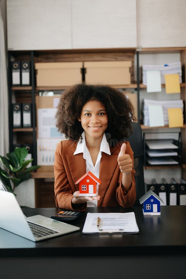 Young Real Estate Agent Worker Working with Laptop and Tablet at Table